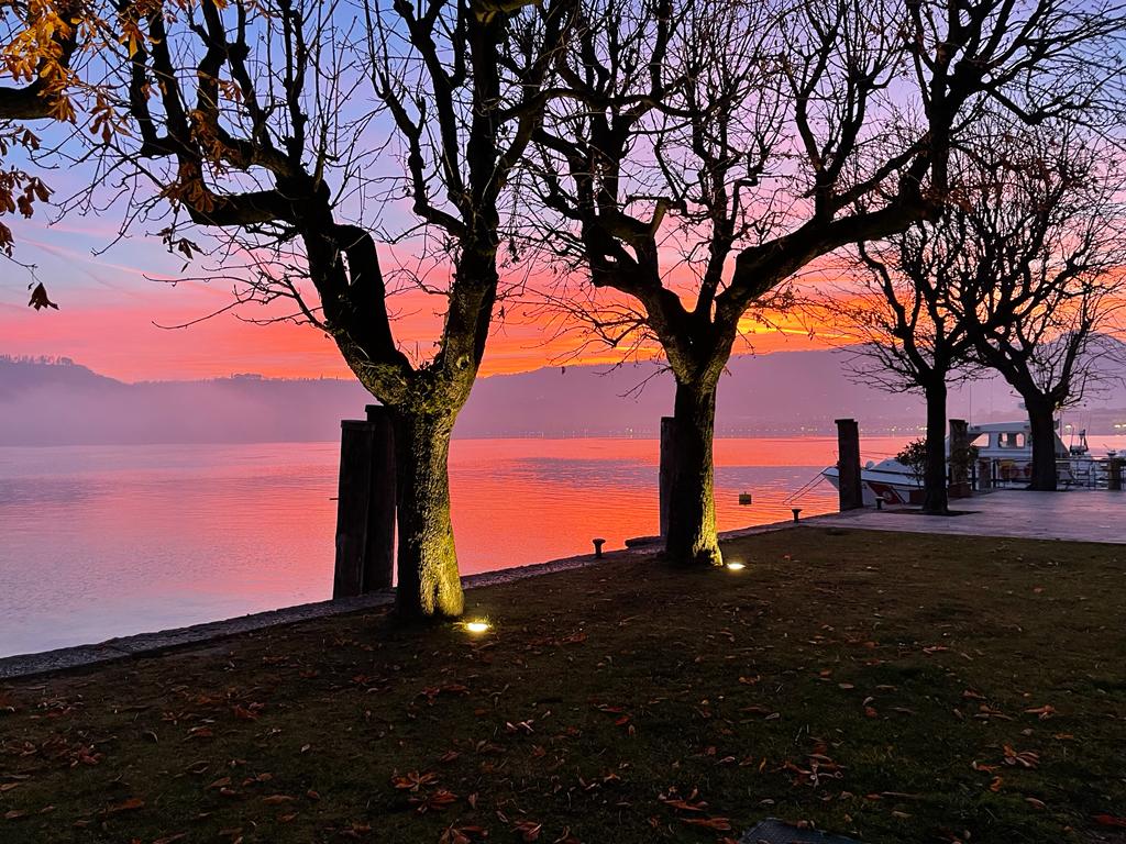 Sunset over the pier on the west shore of Lake Garda on a July evening